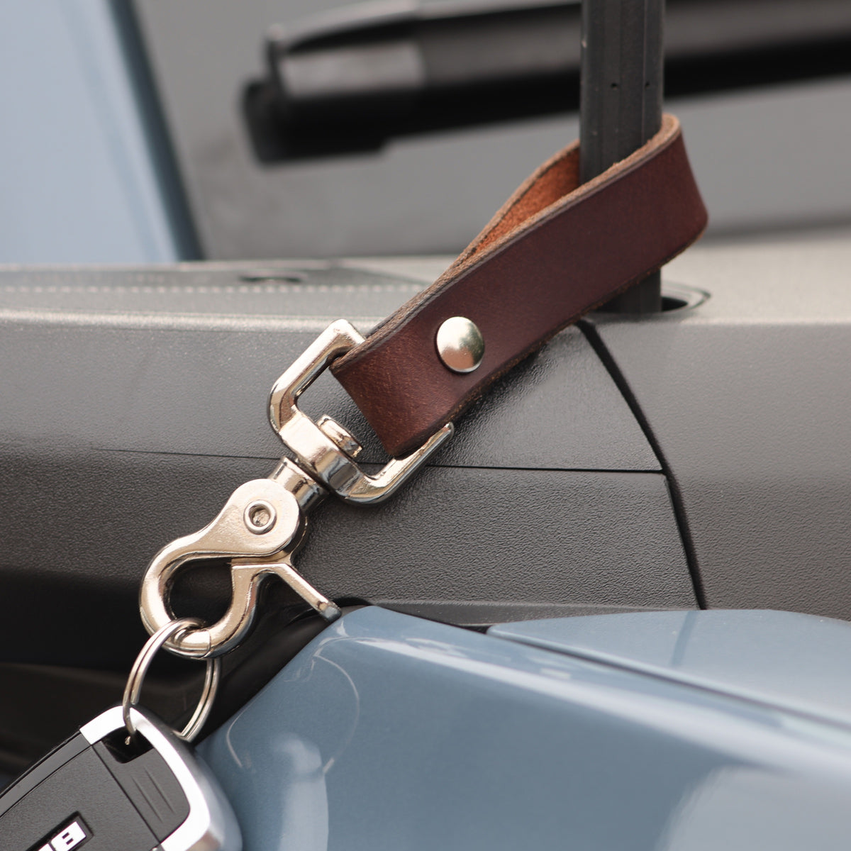 The Clutch keychain in Brown, suede back detail