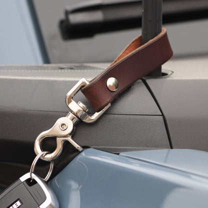 The Clutch keychain in Brown, suede back detail