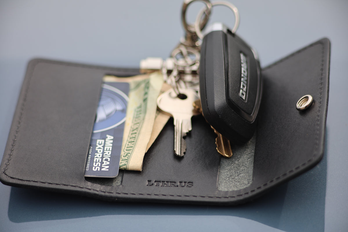 The Fort Wayne trifold key wallet in Black, open with cards, cash and keys