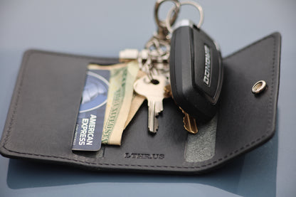 The Fort Wayne trifold key wallet in Black, open with cards, cash and keys