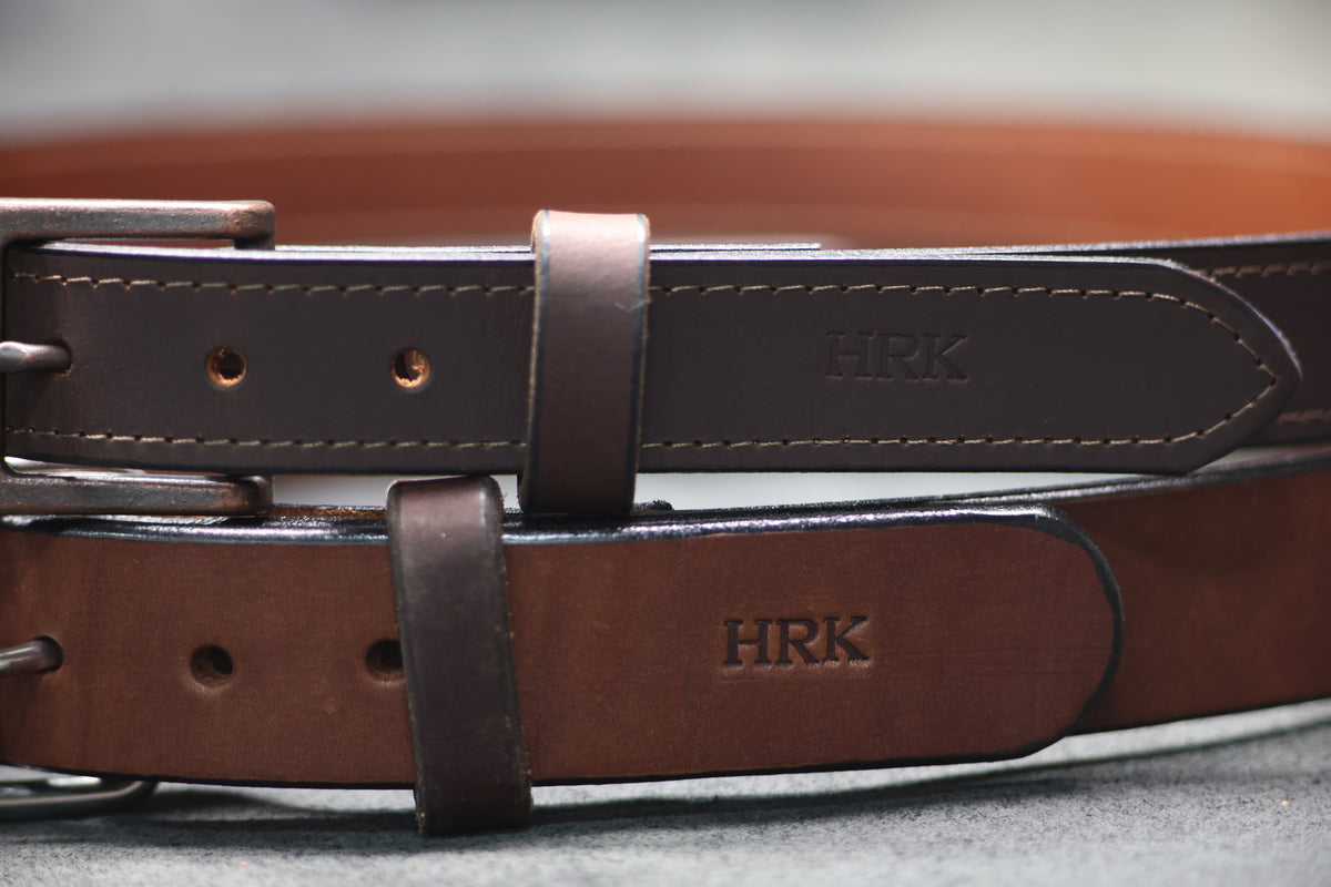 Two LTHR belts monogrammed HRK on the belt tail